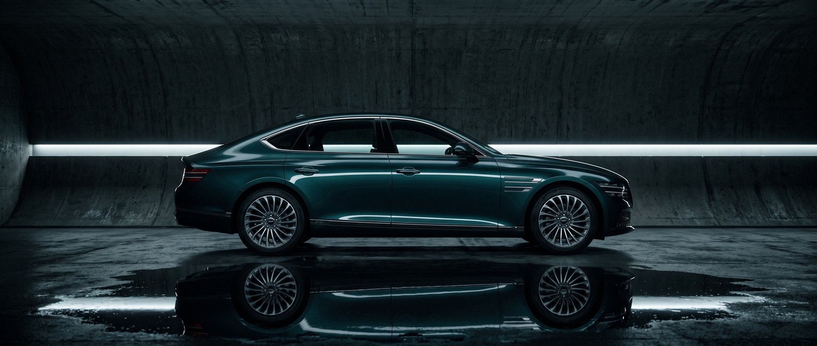 Full side profile of the AURION X in a concrete tunnel, a strip of white light running behind the teal bodywork